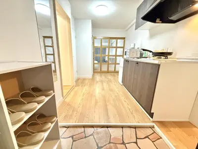 a kitchen with wooden floors and a counter top at Shinjuku Waseda\u30cf\u30a6\u30b9 T3 in Tokyo