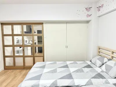 a white bedroom with a bed with a checkered mattress at Shinjuku Waseda\u30cf\u30a6\u30b9 T3 in Tokyo