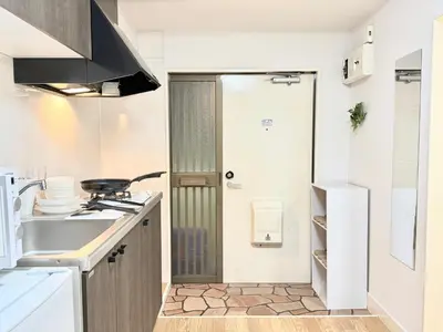 a small kitchen with a stove and a sink at Shinjuku Waseda\u30cf\u30a6\u30b9 T3 in Tokyo