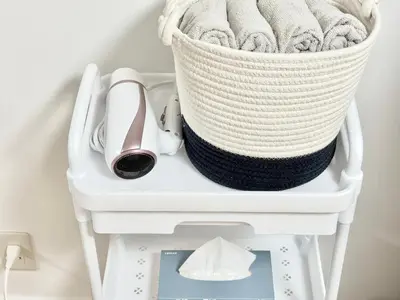 a basket of towels and a high heel shoe on a shelf at Shinjuku Waseda\u30cf\u30a6\u30b9 T3 in Tokyo