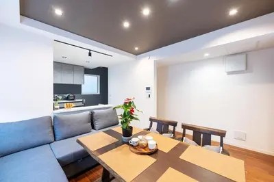 a living room with a blue couch and a table at Newly Built 3-Story House in the Heart of Tokyo-Easy Access to Airports,Skytree in Tokyo