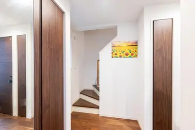 a hallway with a staircase in a house at Newly Built 3-Story House in the Heart of Tokyo-Easy Access to Airports,Skytree in Tokyo