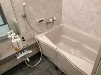 a bathroom with a white tub and a sink at Holiday Anytel Shinjuku#3 in Tokyo
