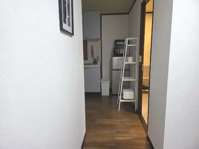a hallway with a kitchen and a ladder in a room at Holiday Anytel Shinjuku#3 in Tokyo