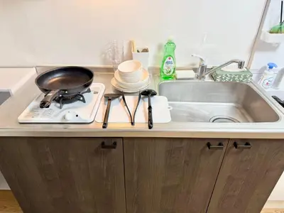 a kitchen counter with a sink and a pan on a stove at Shinjuku Waseda\u30cf\u30a6\u30b9 T4 in Tokyo