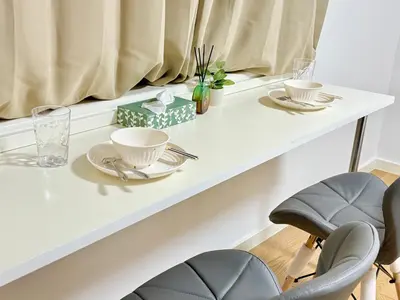 a white table with two cups and plates on it at Shinjuku Waseda\u30cf\u30a6\u30b9 T4 in Tokyo