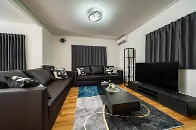 a living room with a couch and a table at Kokoon Hotel Aoto in Tokyo