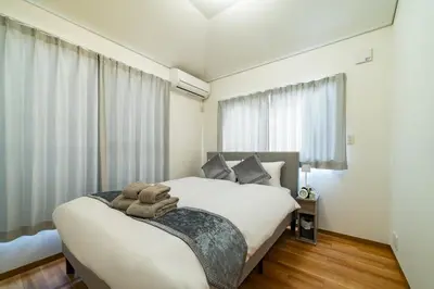a bedroom with a bed with towels on it at Kokoon Hotel Aoto in Tokyo