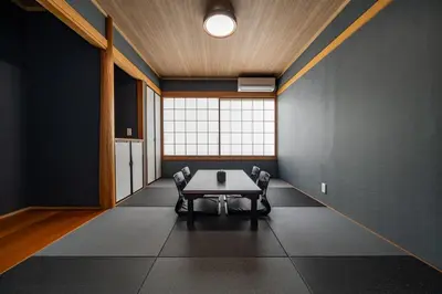 a room with a table and chairs in it at Kokoon Hotel Aoto in Tokyo