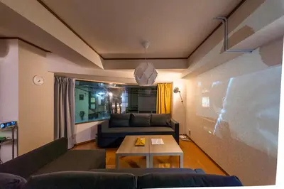 a living room with a couch and a table at SATELLITE HOTEL Komagome \u30b5\u30c6\u30e9\u30a4\u30c8\u30db\u30c6\u30eb\u99d2\u8fbc in Tokyo