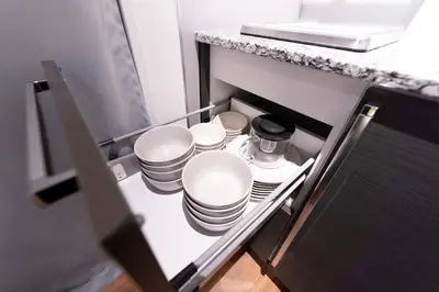 a stack of plates and cups in a cabinet at SATELLITE HOTEL Komagome \u30b5\u30c6\u30e9\u30a4\u30c8\u30db\u30c6\u30eb\u99d2\u8fbc in Tokyo