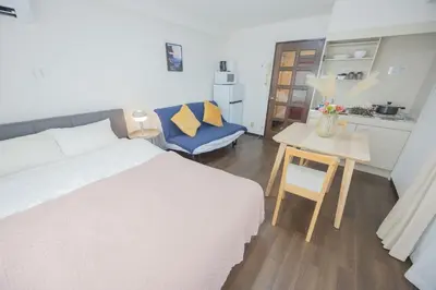 a bedroom with a bed and a table and a chair at Palasto Hostel-SJ0002 in Tokyo