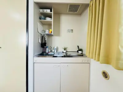 a small white kitchen with a sink and a window at Palasto Hostel-SJ0002 in Tokyo