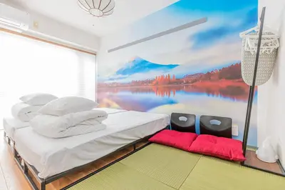 a bedroom with a large painting on the wall at FRt\u6075\u6bd4\u5bff2\u4e01\u76ee305 in Tokyo