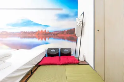 a bedroom with two chairs and a view of a lake at FRt\u6075\u6bd4\u5bff2\u4e01\u76ee305 in Tokyo
