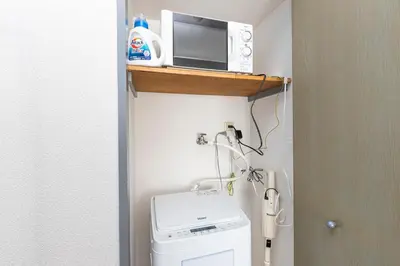 a small bathroom with a toilet and a microwave at FRt\u6075\u6bd4\u5bff2\u4e01\u76ee305 in Tokyo