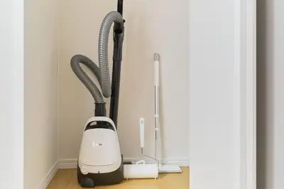 a vacuum cleaner is next to a door at Ruygo Setagaya by Tranova in Tokyo