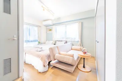 a white bedroom with a bed and a chair at FRt\u6075\u6bd4\u5bff2\u4e01\u76ee306 in Tokyo