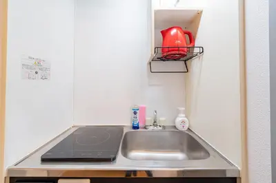 a kitchen with a sink and a red kettle on a shelf at FRt\u6075\u6bd4\u5bff2\u4e01\u76ee306 in Tokyo