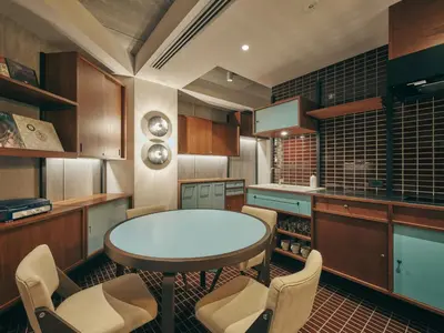 a kitchen with a table and chairs in it at illi Amu Shimokitazawa in Tokyo