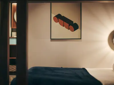 a bedroom with a bed and a picture on the wall at illi Amu Shimokitazawa in Tokyo