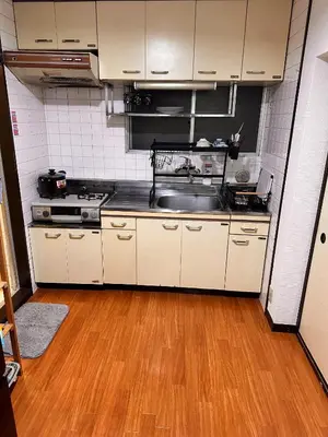a kitchen with white cabinets and a wooden floor at ZYZSumiyoshichō 2K SJ0254 in Tokyo
