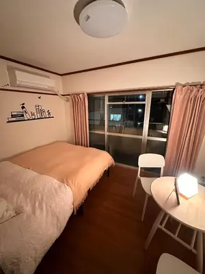 a bedroom with a bed and a table and a window at ZYZSumiyoshichō 2K SJ0254 in Tokyo