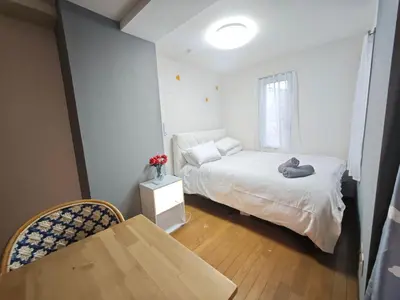 a small bedroom with a bed and a table at ZYZHigashinippori 1DK AK0255 in Tokyo