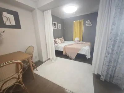 a small bedroom with a bed and a desk at ZYZHigashinippori 1DK AK0255 in Tokyo