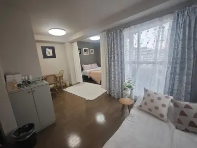 a living room with a bed and a window at ZYZHigashinippori 1DK AK0255 in Tokyo