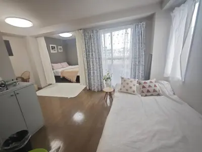 a bedroom with a bed and a large window at ZYZHigashinippori 1DK AK0255 in Tokyo