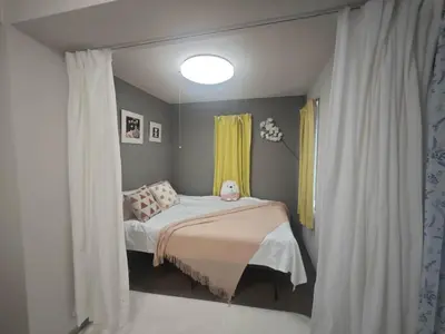 a small bedroom with a bed and a window at ZYZHigashinippori 1DK AK0255 in Tokyo