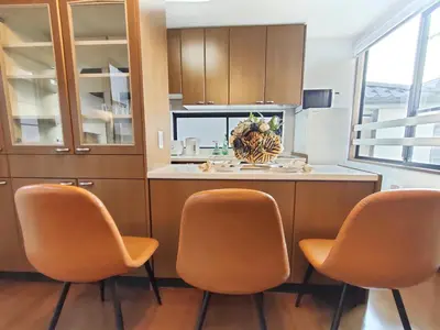 a kitchen with two orange chairs and a counter at \u8fd1\u6c60\u888b 3\u5c42\u522b\u5885 \u5168\u65b0\u88c5\u4fee \u8f66\u7ad97\u5206\u949f 4\u5ba41\u53851\u6d74\u5ba41\u536b\u751f\u95f4 \u8bbe\u65bd\u9f50\u5168 \u6700\u59278\u4ebaEasy Access to Shinjuku Ikebukuro 4 rooms 1dining room 1 bathrooms 1toilets Max 8P 7mins to St a in Tokyo