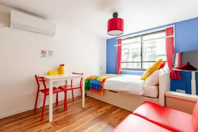 a small bedroom with a bed and a table at \u6d45\u8349\u6a4b201 in Tokyo