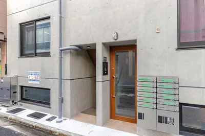 a building with a wooden door and a building with at \u6d45\u8349\u6a4b201 in Tokyo