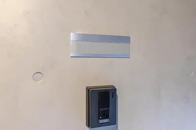 a sign on a wall with a pay phone at \u6d45\u8349\u6a4b201 in Tokyo