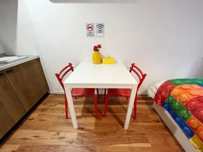 a white table and chairs in a room with a bed at \u6d45\u8349\u6a4b201 in Tokyo