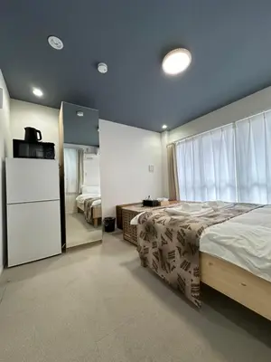 a bedroom with a large bed and a refrigerator at \u798f\u30db\u30c6\u30eb501 in Tokyo