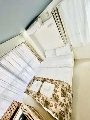 a small bedroom with a bed and a window at \u798f\u30db\u30c6\u30eb501 in Tokyo