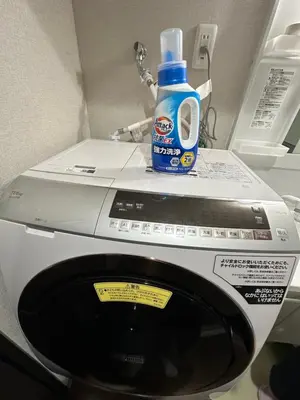 a bottle of detergent sitting on top of a washing machine at \u798f\u30db\u30c6\u30eb501 in Tokyo