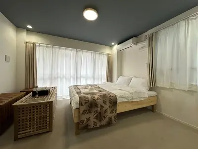 a bedroom with a large bed and a window at \u798f\u30db\u30c6\u30eb501 in Tokyo