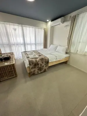 a bedroom with a bed and a large window at \u798f\u30db\u30c6\u30eb501 in Tokyo