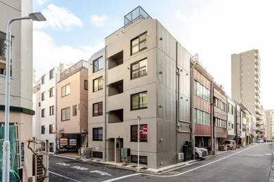 a tall building on a city street with buildings at \u6d45\u8349\u6a4b202 in Tokyo