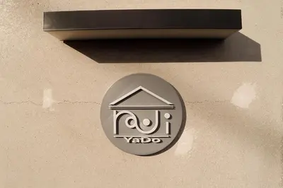 a sign on the side of a building at \u30a2\u30f3\u30c9\u30b9\u30c6\u30a4\u5343\u4f4f\u5bff\u753a in Tokyo
