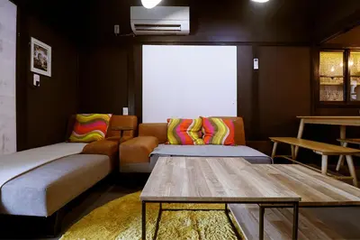 a living room with a couch and a table at \u30a2\u30f3\u30c9\u30b9\u30c6\u30a4\u5343\u4f4f\u5bff\u753a in Tokyo