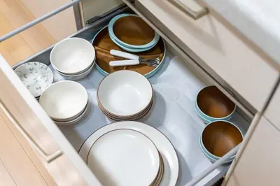 a drawer full of bowls and plates in a cabinet at Y's INN 北砂 101T in Tokyo