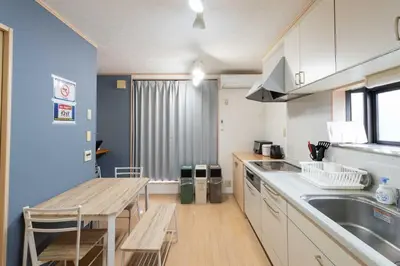 a kitchen with a table and a sink and a counter at Y's INN 北砂 101T in Tokyo