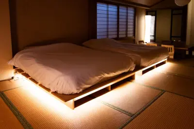 a bed with a light on the floor in a room at Sky Tree View Asakusa in Tokyo