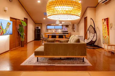 a living room with a couch and a chandelier at Sky Tree View Asakusa in Tokyo