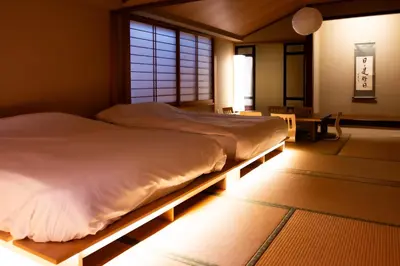 a large bed in a room with a window at Sky Tree View Asakusa in Tokyo